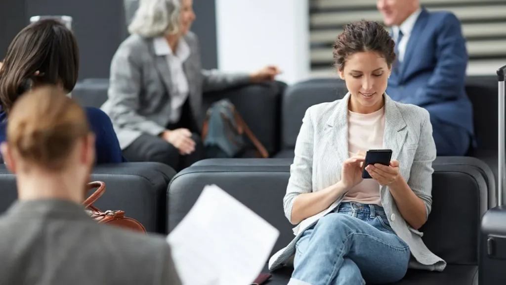 Girl using free Wi-Fi on phone at JFK Airport